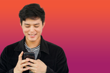 Man checking notifications on his phone and smiling.